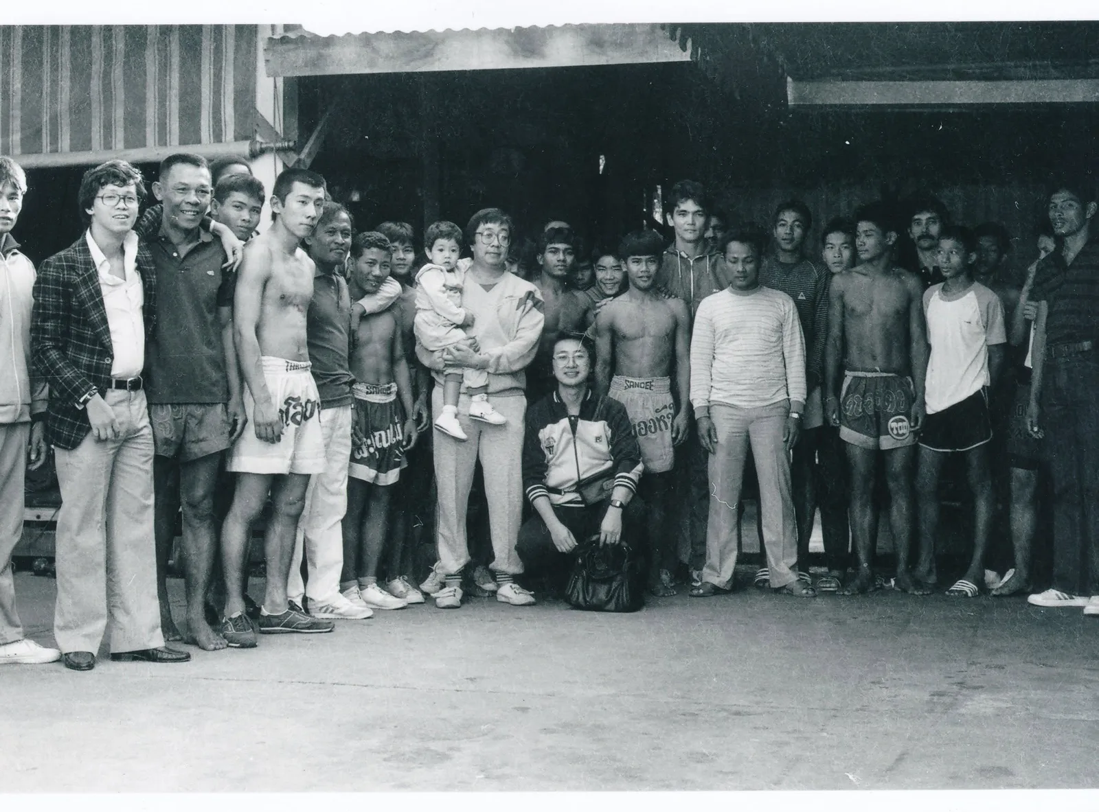 Don Wilson (centre) training in Fairtex Gym, with Philip Wong (carrying a baby) and muaythai legend Apidej on the left, 1983. Photo courtesy of former reported Mr. Hui Ho.
