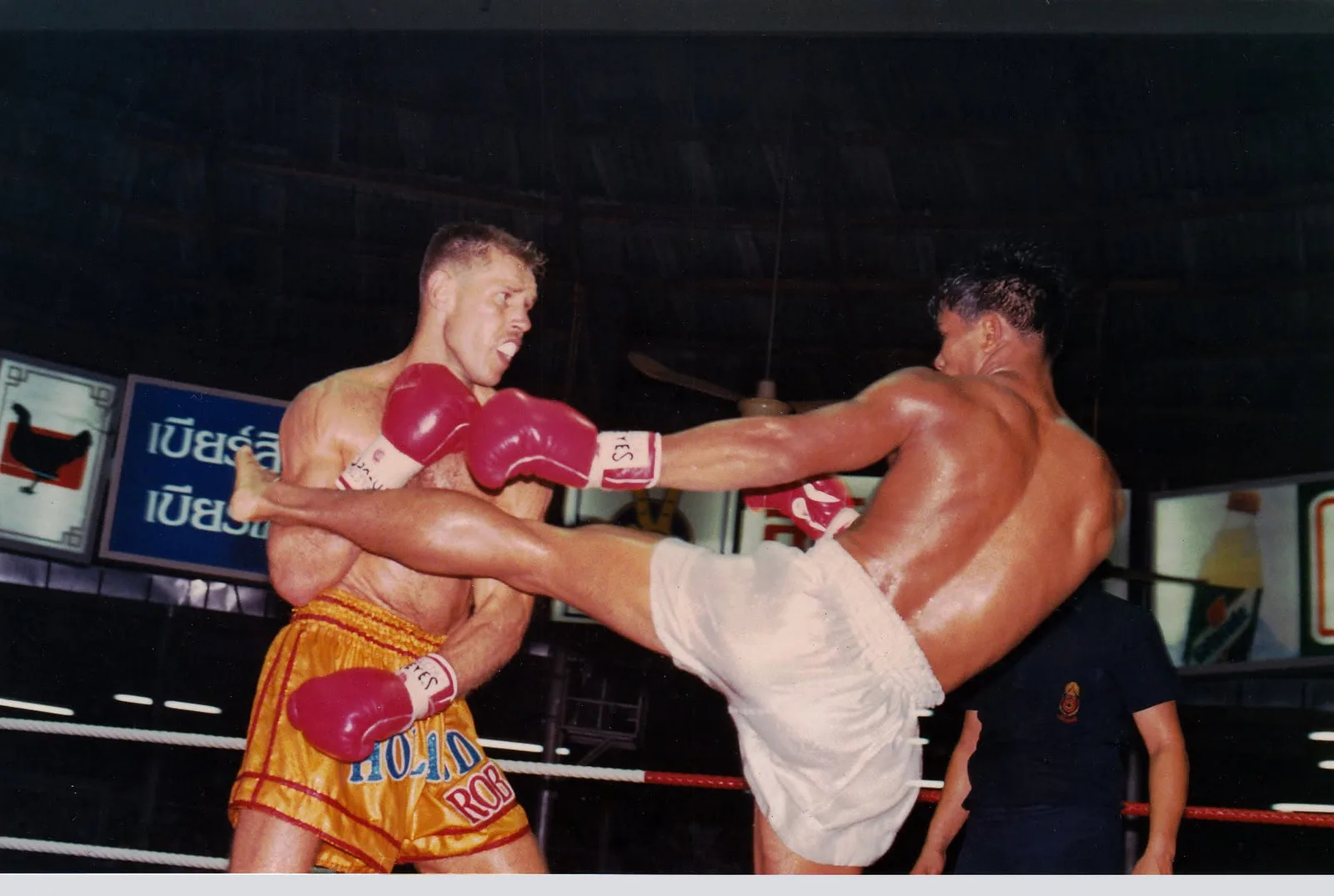 Kaman taking a lot of punishment from the Thai's lethal left kick. It was a hectic struggle through five heated rounds.